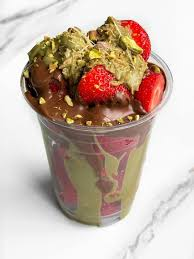 Strawberry cake cup topped with pistachio, Belgian chocolate and white chocolate sauce from Desi Cakes & Shakes Oldham